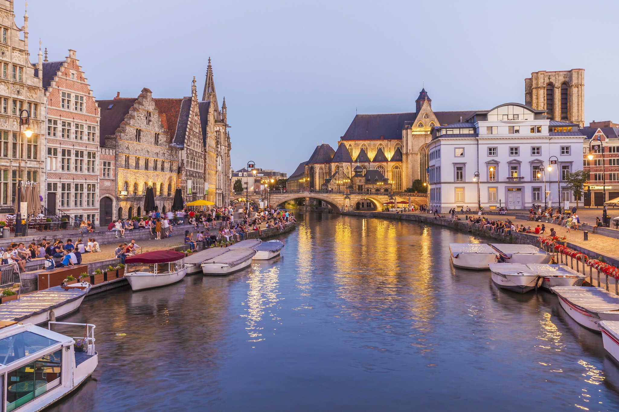 Korenlei and Graslei on the River Leie in Ghent's old town at dusk.
597070535
water, illuminated, Idyllic, promenade, waterfront promenade, built structure, building, house, row of houses, Leie, city, Old Town, historic old town, Belgium, Flanders, East Flanders, Ghent, River, twilight, evening twilight, evening, outdoor, city view, Light, Travel, Travel destination, history, historical, Korenlei, vehicle, Nautical Vessel, boat, excursion boat, Graslei, illumination, Architecture, urban scene, Incidental People, landmark, sky, blue sky, waters edge, riverside, tourism, City Break, mooring area, History, In A Row, Excursion Boat, Twilight, Outdoors, Illumination, Sky, Ghent - Belgium, Building, Travel Destinations, Horizontal, Riverside, Famous Place, Mode of Transport, Historic Old Town, City, Flanders - Belgium, Promenade, Light - Natural Phenomenon, Photography, Waterfront, Twilights, 2015, Water's Edge, Color Image, House, Illuminated, Tourism, Dusk, Built Structure, Cityscape, Blue, Water
