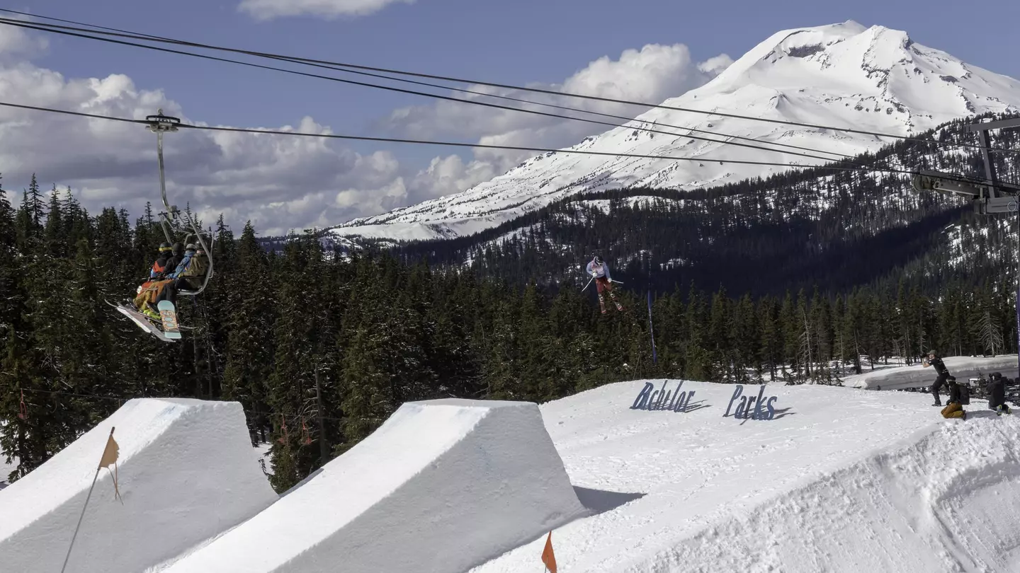 Skiers on chair lift take in big air Ski jumper at Mount Bachelor in Oregon