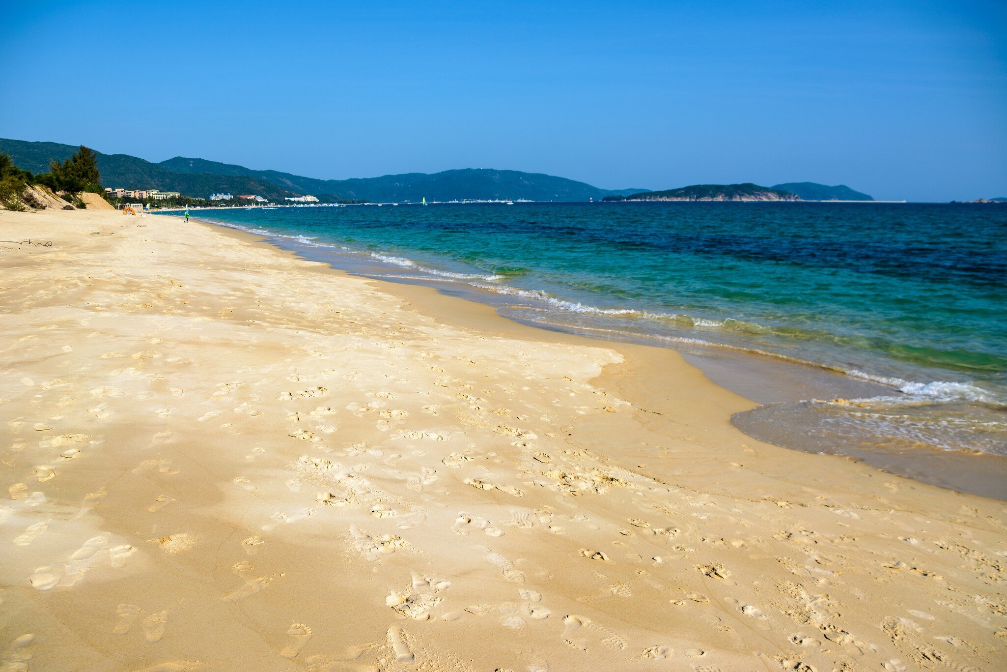 Sunny day, sand creaking, clear turquoise sea, coral reefs on the coast of Yalong Bay in South China Sea. Sanya, island Hainan, China. Nature Landscape., License Type: media, Download Time: 2026-09-02T16:20:37.000Z, User: LP_NZhan, Editorial: false, purchase_order: 65050 - Digital Destinations and Articles, job: App Content, client: Lonely Planet App, other: Nadine Zhan