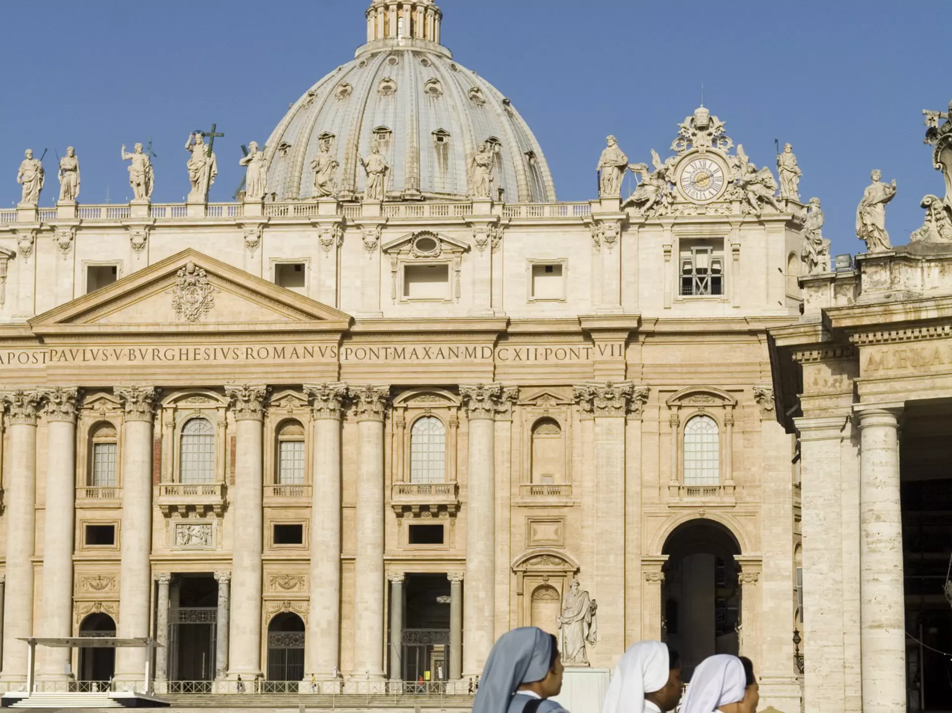 Nuns walk past St Peter's Basilica in Rome, Italy. 