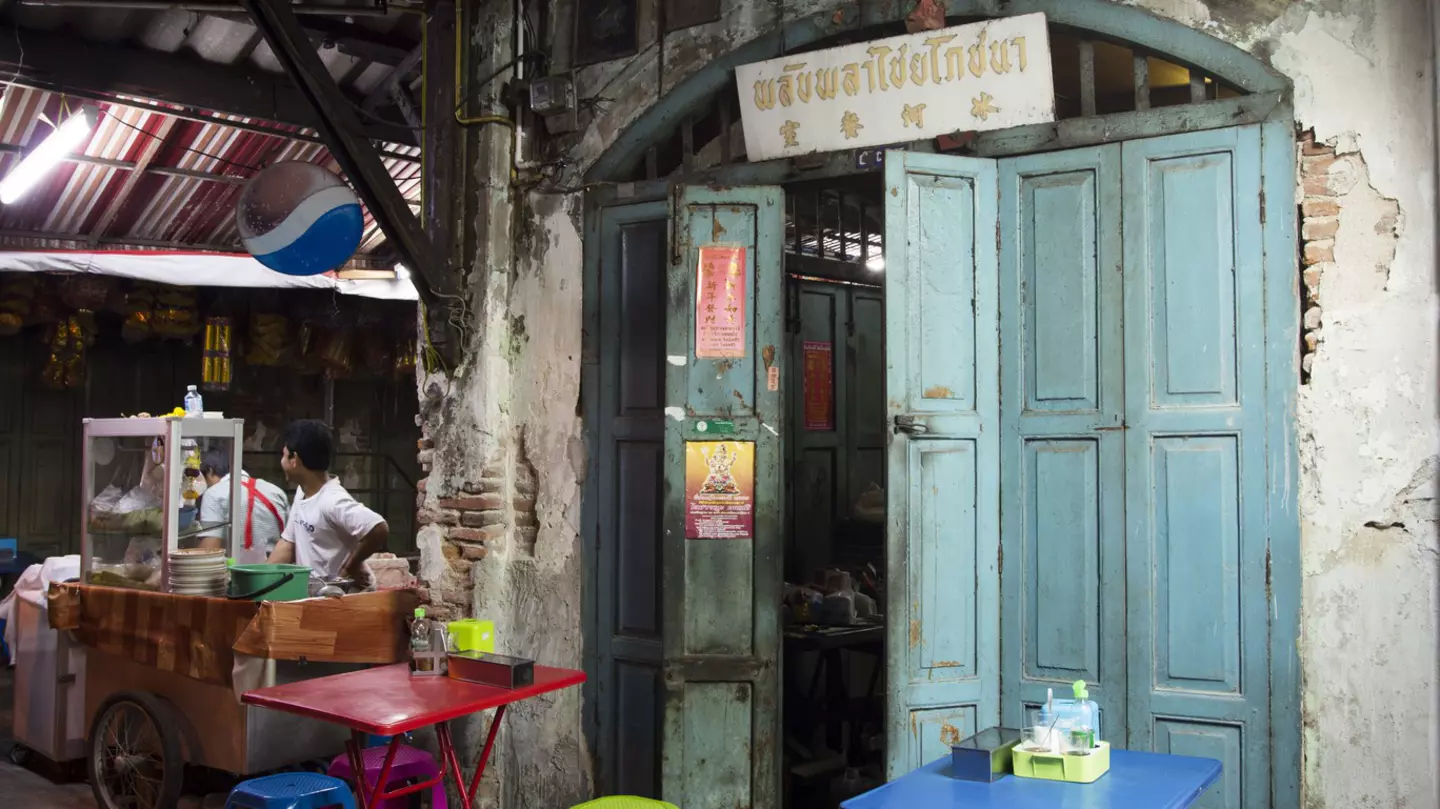 A woman holds a plastic bottle to the mouth of a baby rhino at Kruger National Park Rhino orphanage