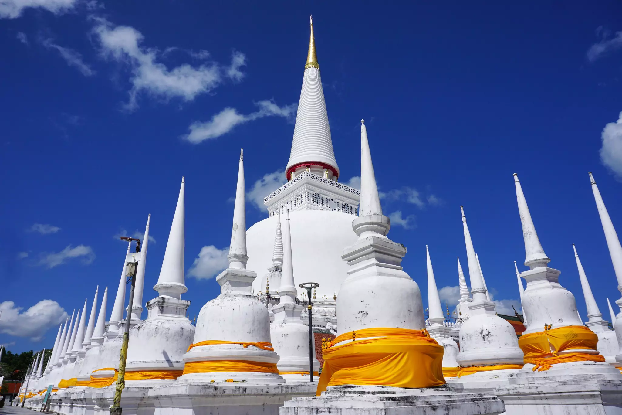 White stupas at Wat Phra Mahathat Woramahawihaan, Nakhon Si Thammarat, Thailand.