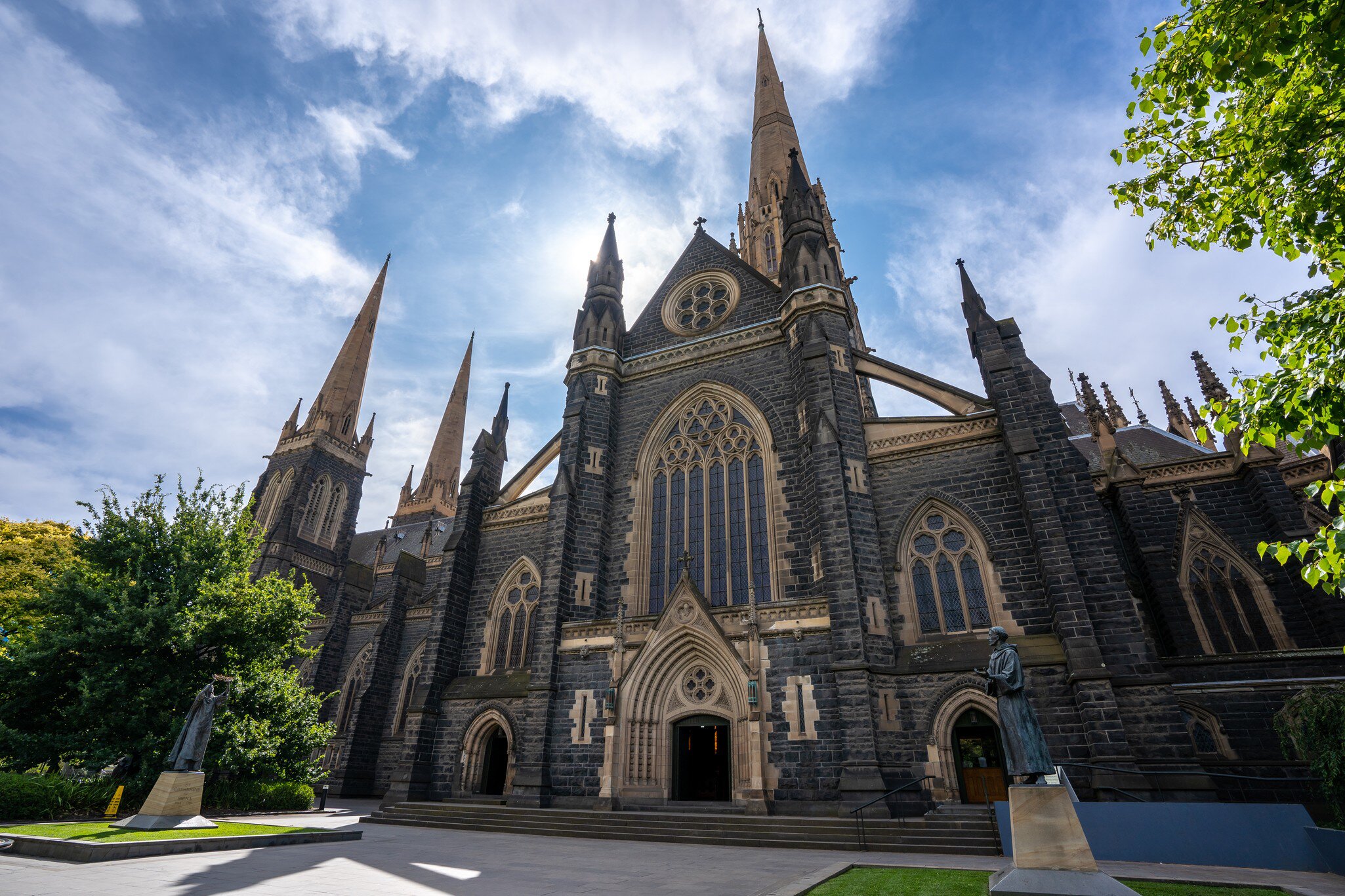 Facade of St Patrick's Cathedral below a blue sky at Eastern hill in Melbourne, Victoria, Australia.