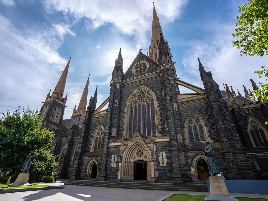 Facade of St Patrick's Cathedral below a blue sky at Eastern hill in Melbourne, Victoria, Australia.