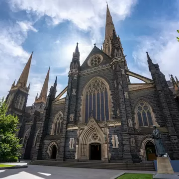 Facade of St Patrick's Cathedral below a blue sky at Eastern hill in Melbourne, Victoria, Australia.