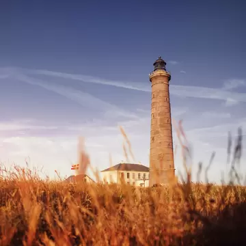 The famous Skagen Grey Lighthouse in colorful sunset light in the sand dunes,. Skagen, Grenen in North Jutland, Denmark.