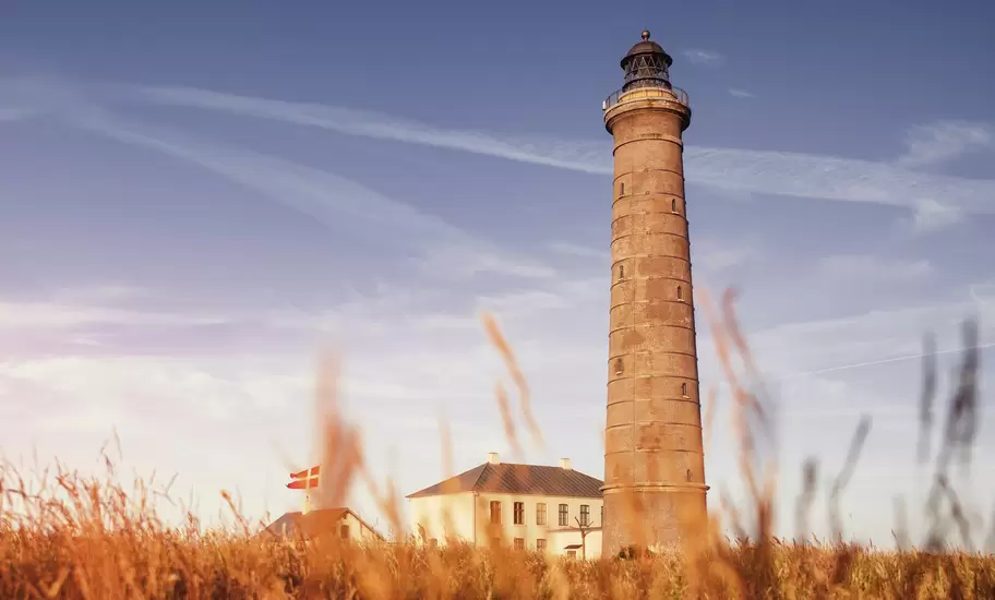 The famous Skagen Grey Lighthouse in colorful sunset light in the sand dunes,. Skagen, Grenen in North Jutland, Denmark.