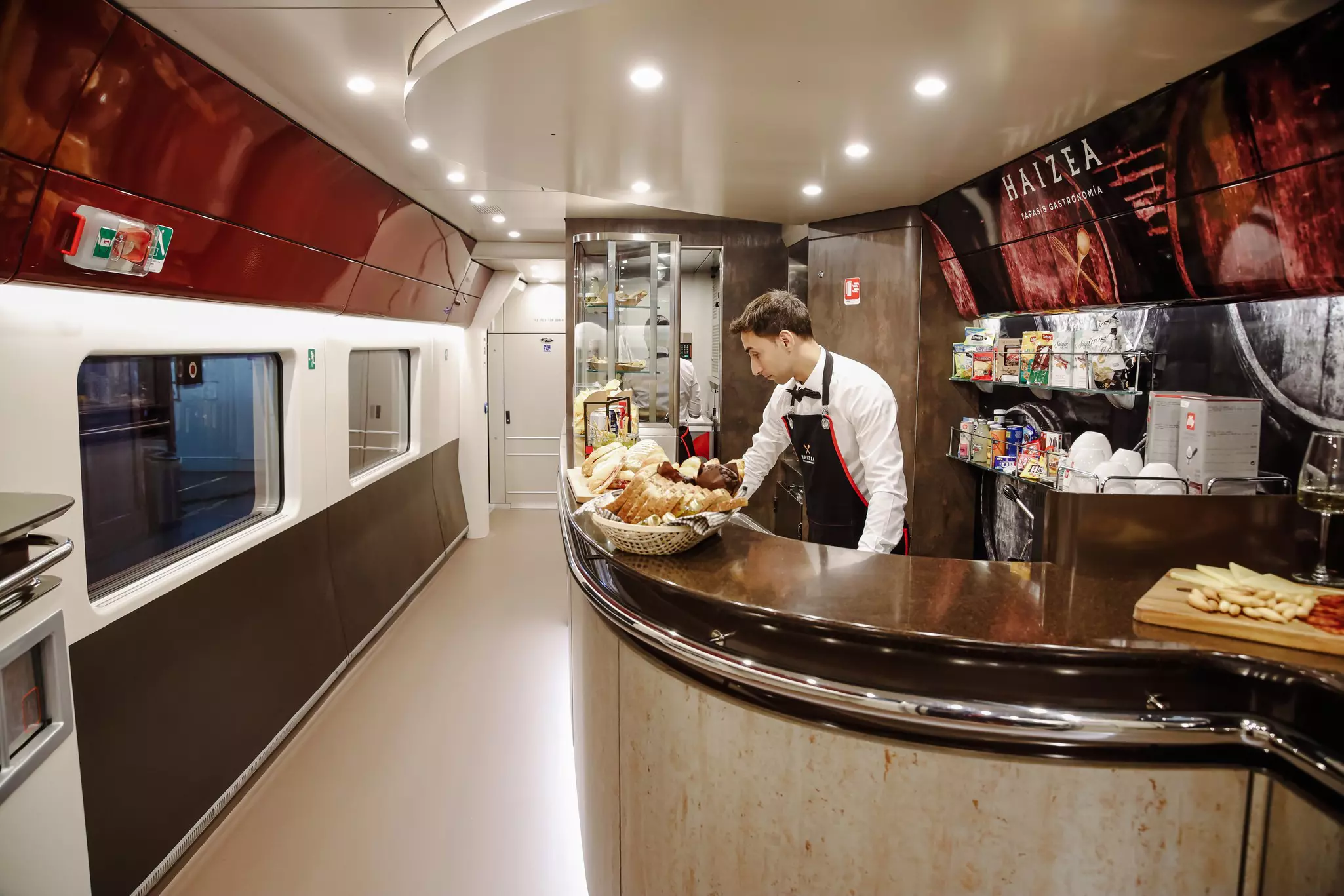 A waiter at the cafeteria inside a train.