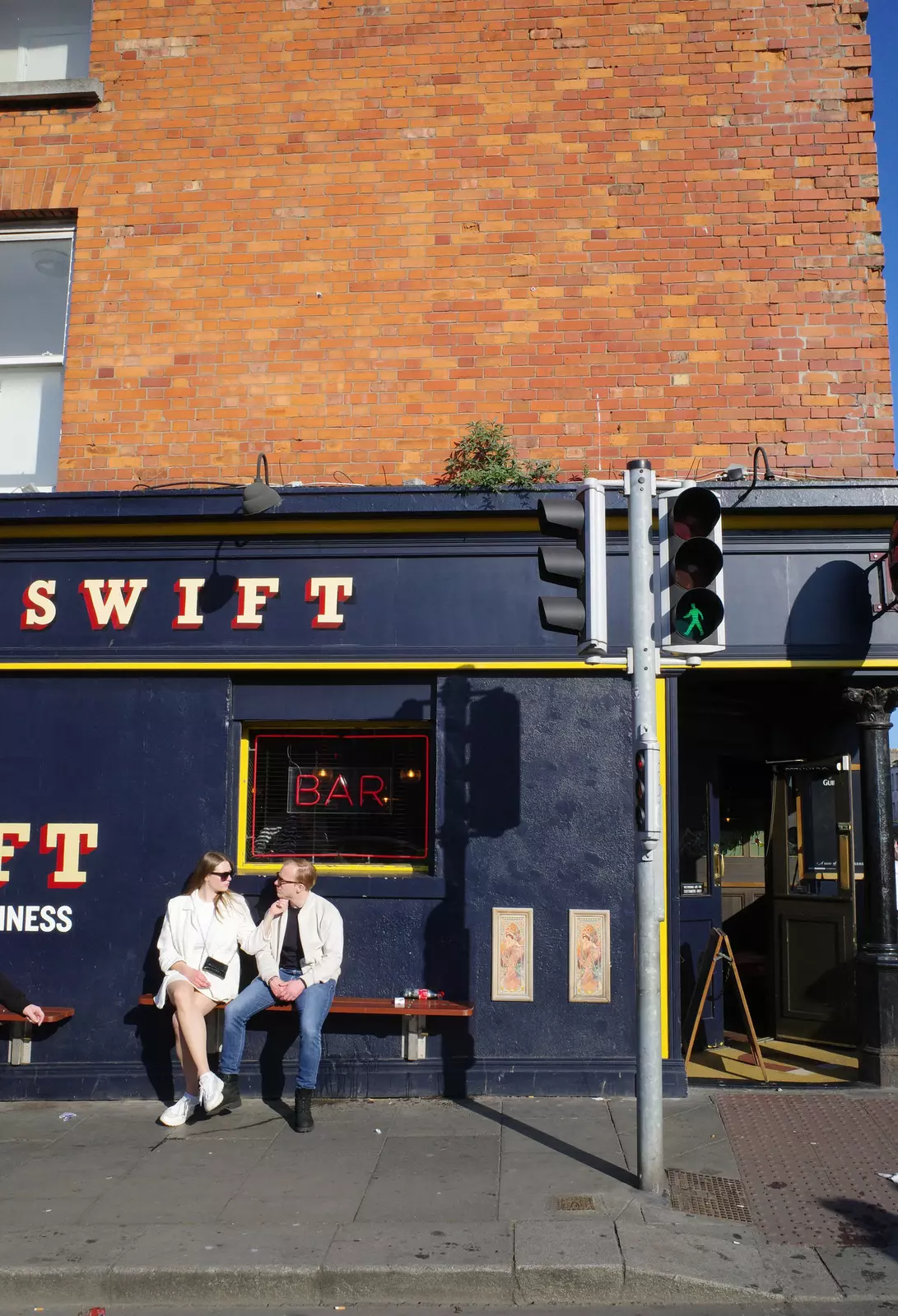 Two people sit outside The Swift Irish Bar in The Liberties, Dublin. 