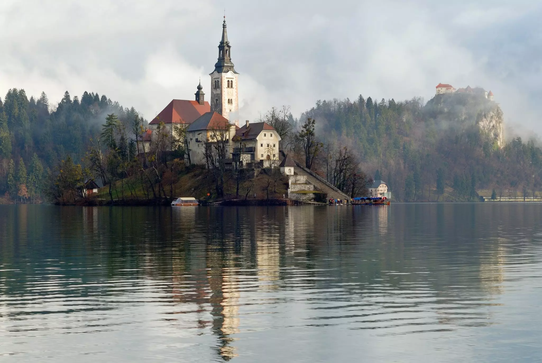 A church located on an island in Lake Bled with a castle in the background, Slovenia. Vara I/Shutterstock