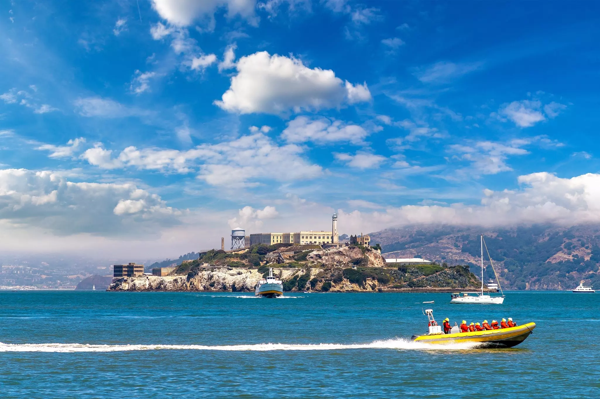 Boats pass by an island prison complex.