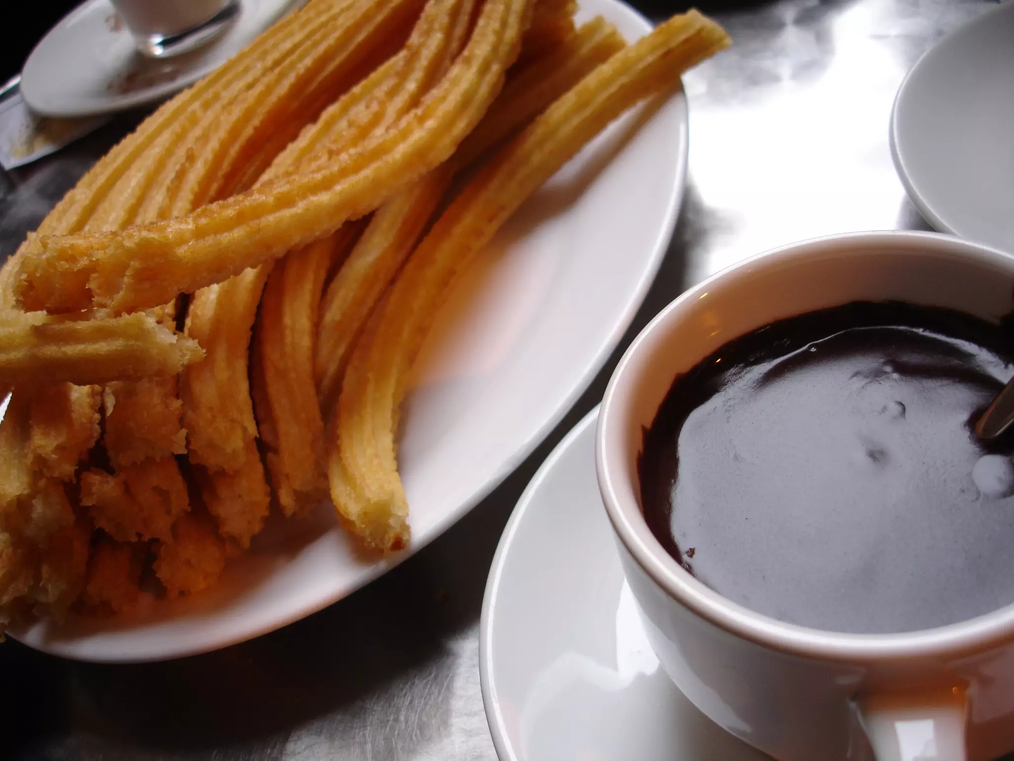 Up close image of churros with hot chocolate in Spain.