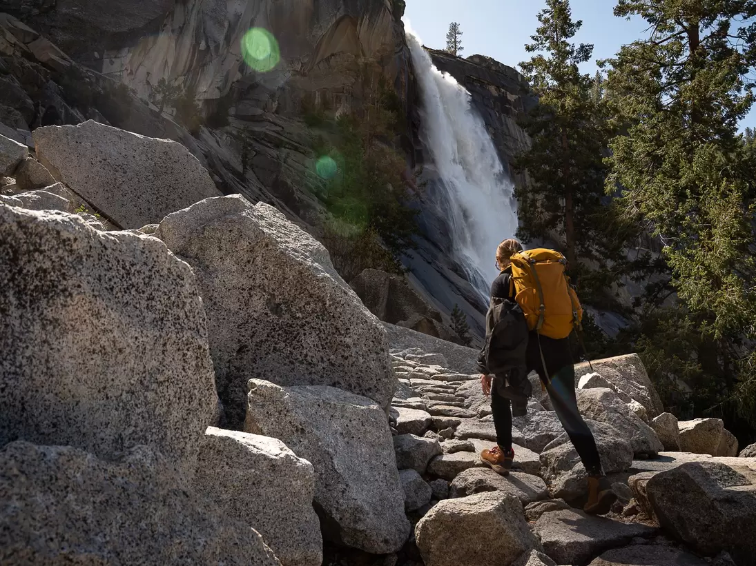 Woman by waterfall Nevada Fall in Yosemite National Park, California