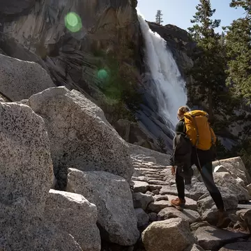 Woman by waterfall Nevada Fall in Yosemite National Park, California
