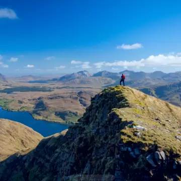 A wide shot of hikers in on a rocky mountain in Connemara, Ireland