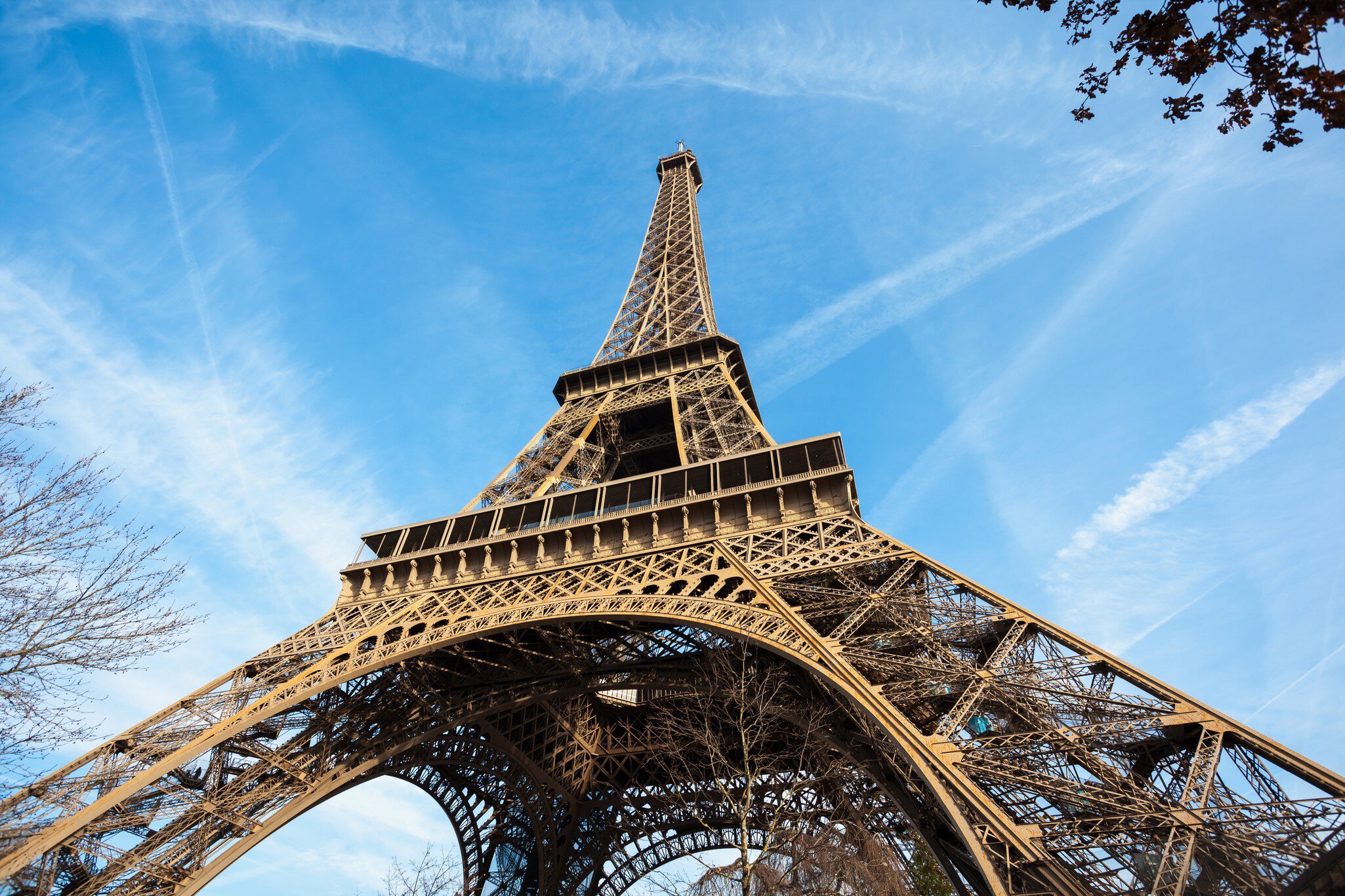 Wide shot of Eiffel Tower with blue sky, Paris, France.
