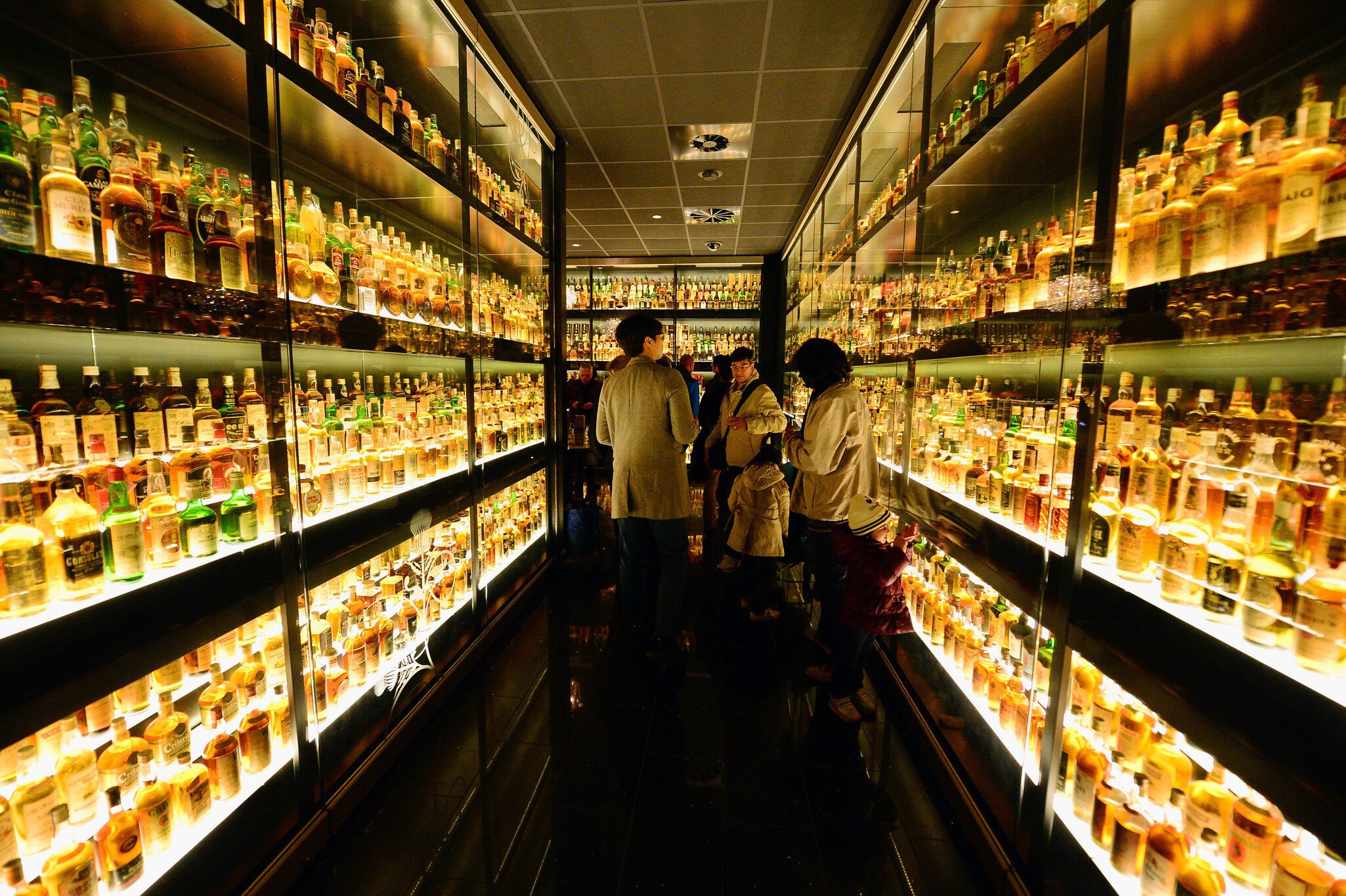 EDINBURGH, SCOTLAND - MARCH 19:  Members of the public view the Diageo Claive Vidiz Collection, the world's largest collection of Scottish Whisky on display at The Scotch Whisky Experience on March 19, 2014 in Edinburgh, Scotland. Chancellor of th...