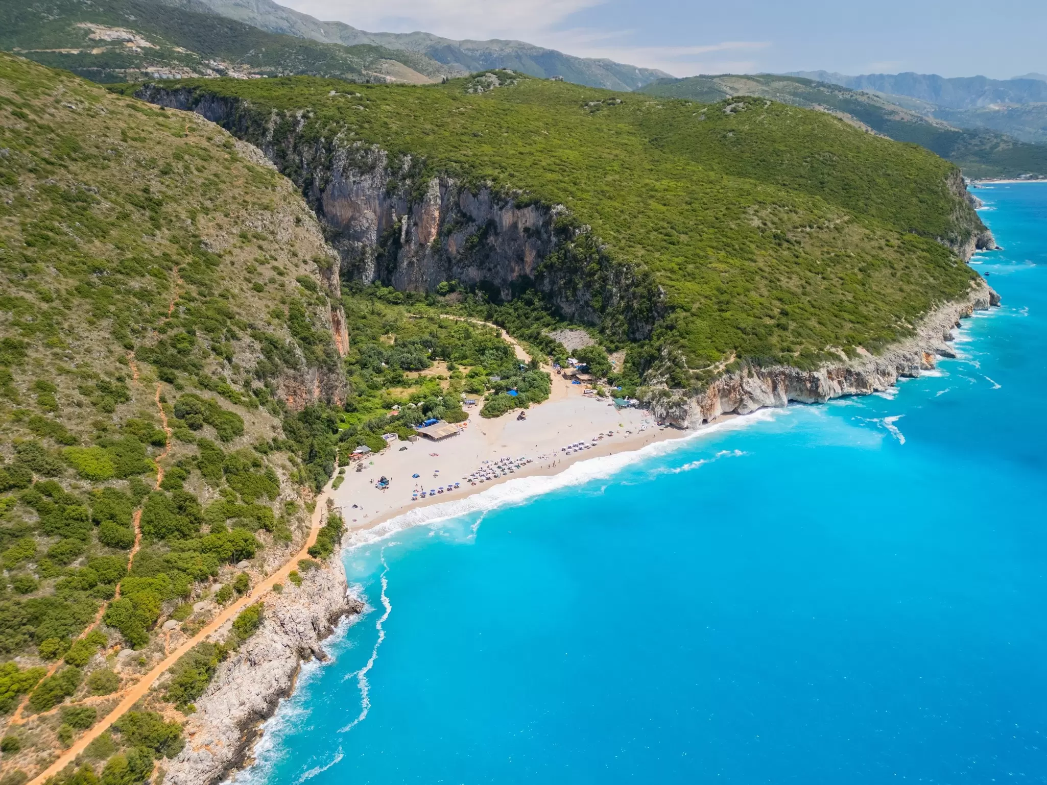 A glorious sandy bay tucked into the cliffs near Dhërmi, Albania