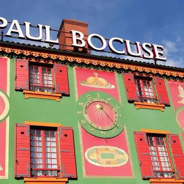 Chef Paul Bocuse outside his flagship restaurant, l'Auberge du Pont de Collonges.
