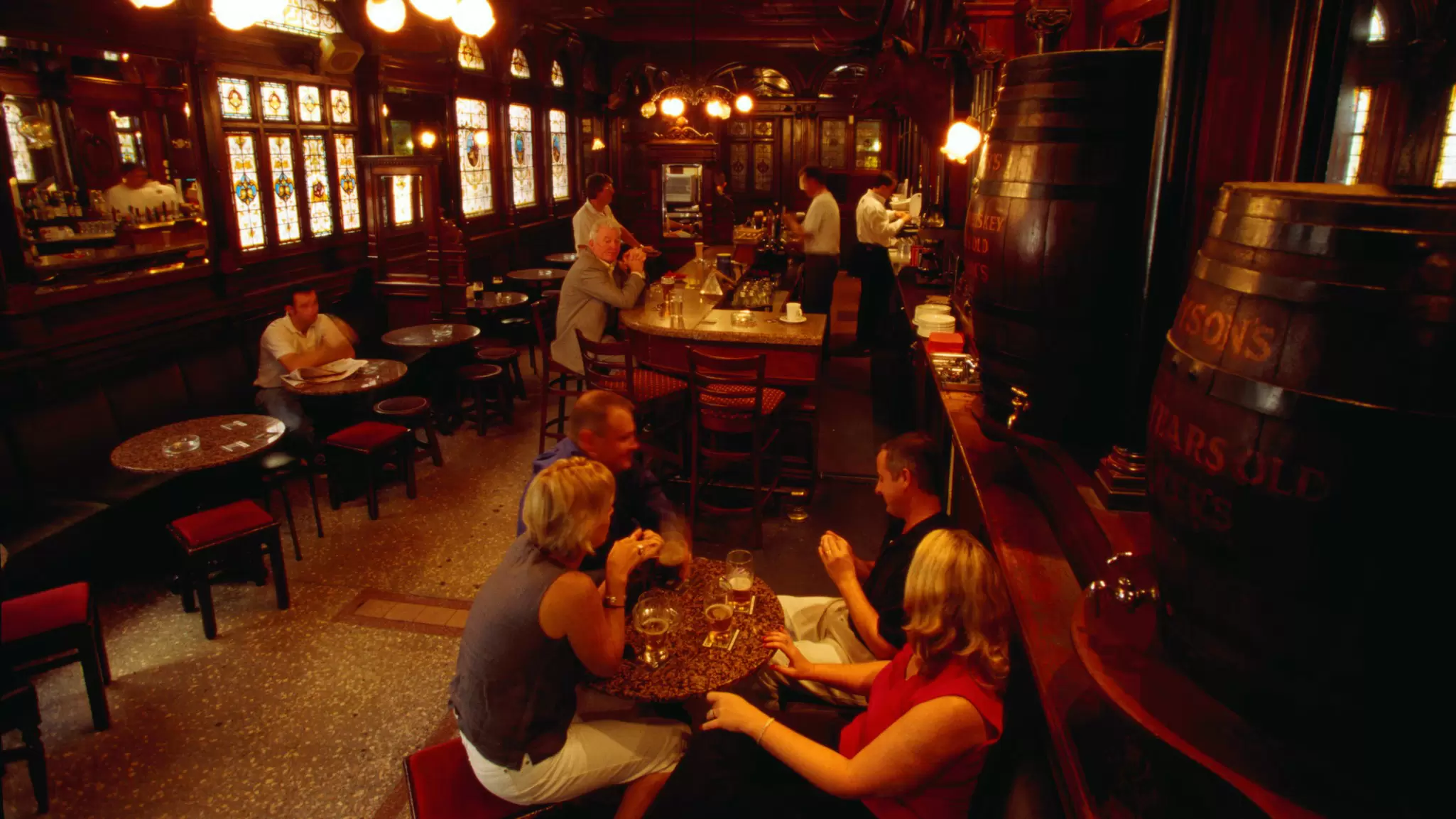 Drinkers in the atmospheric interior of the Stag's Head pub in Dublin, Ireland. Oliver Strewe/Getty Images