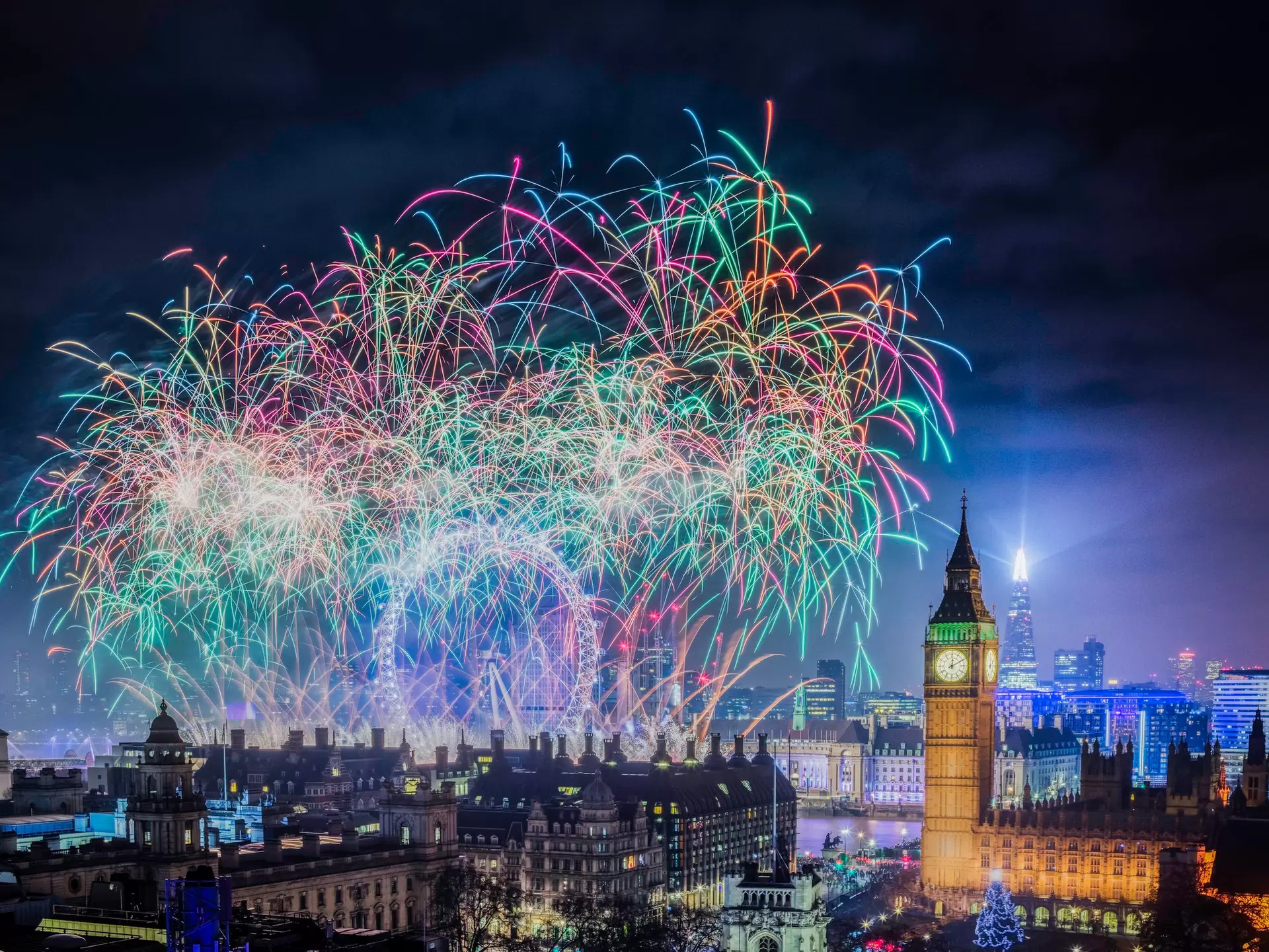 Colorful fireworks in the night sky with Big Ben clocktower in the skyline