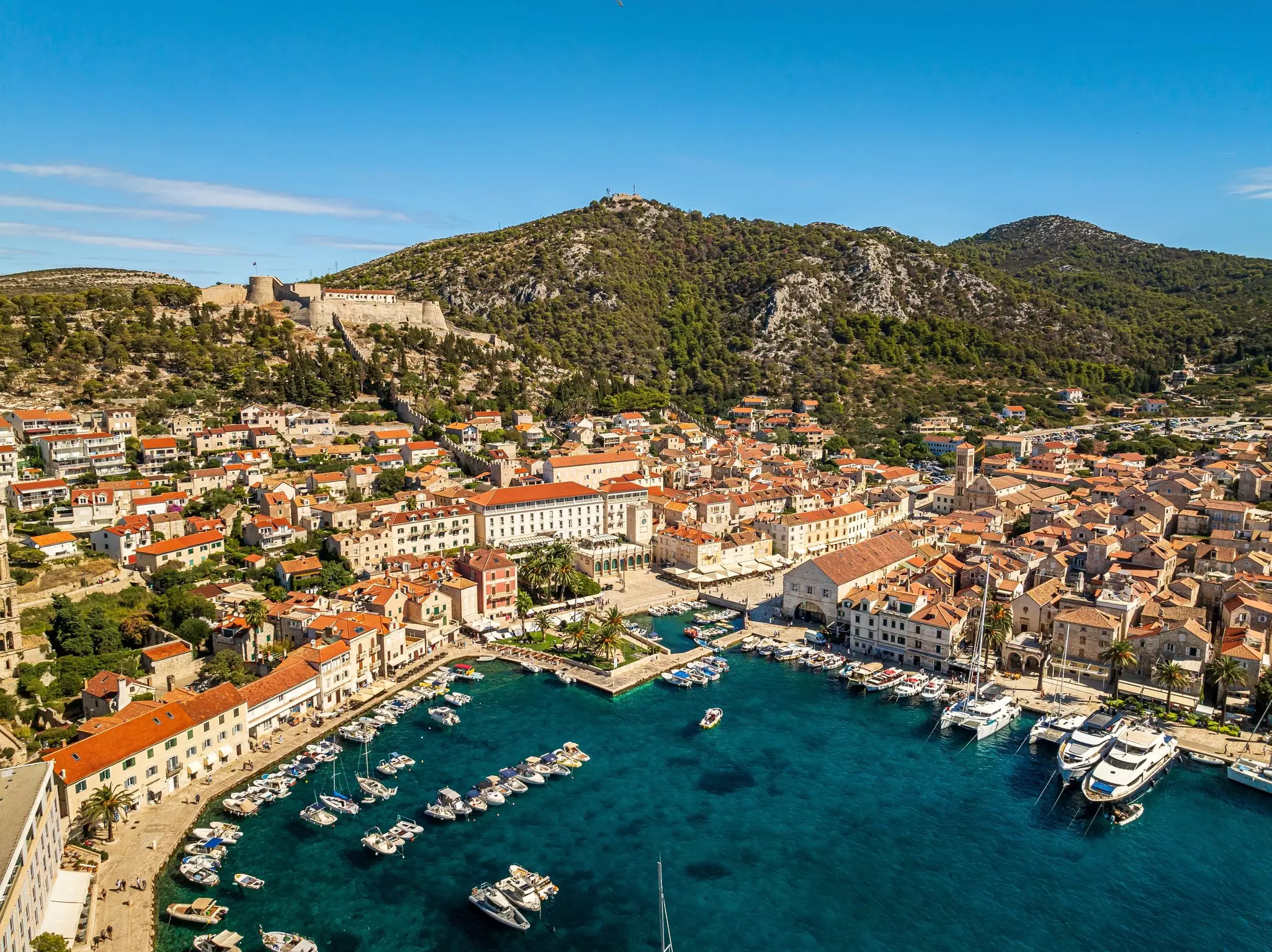 Aerial view of historic Hvar old town with boats and yachts in harbor, Mediterranean coastline, Split-Dalmatia, Croatia., License Type: media, Download Time: 2025-11-21T18:23:38.000Z, User: LP_YKhanna, Editorial: false, purchase_order: 65050 - Digital Destinations and Articles, job: LP, client: App Content, other: Yuvraj Khanna