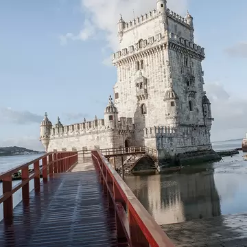 Bridge over water leading toward the Torre de Belém in Lisbon, Portugal.