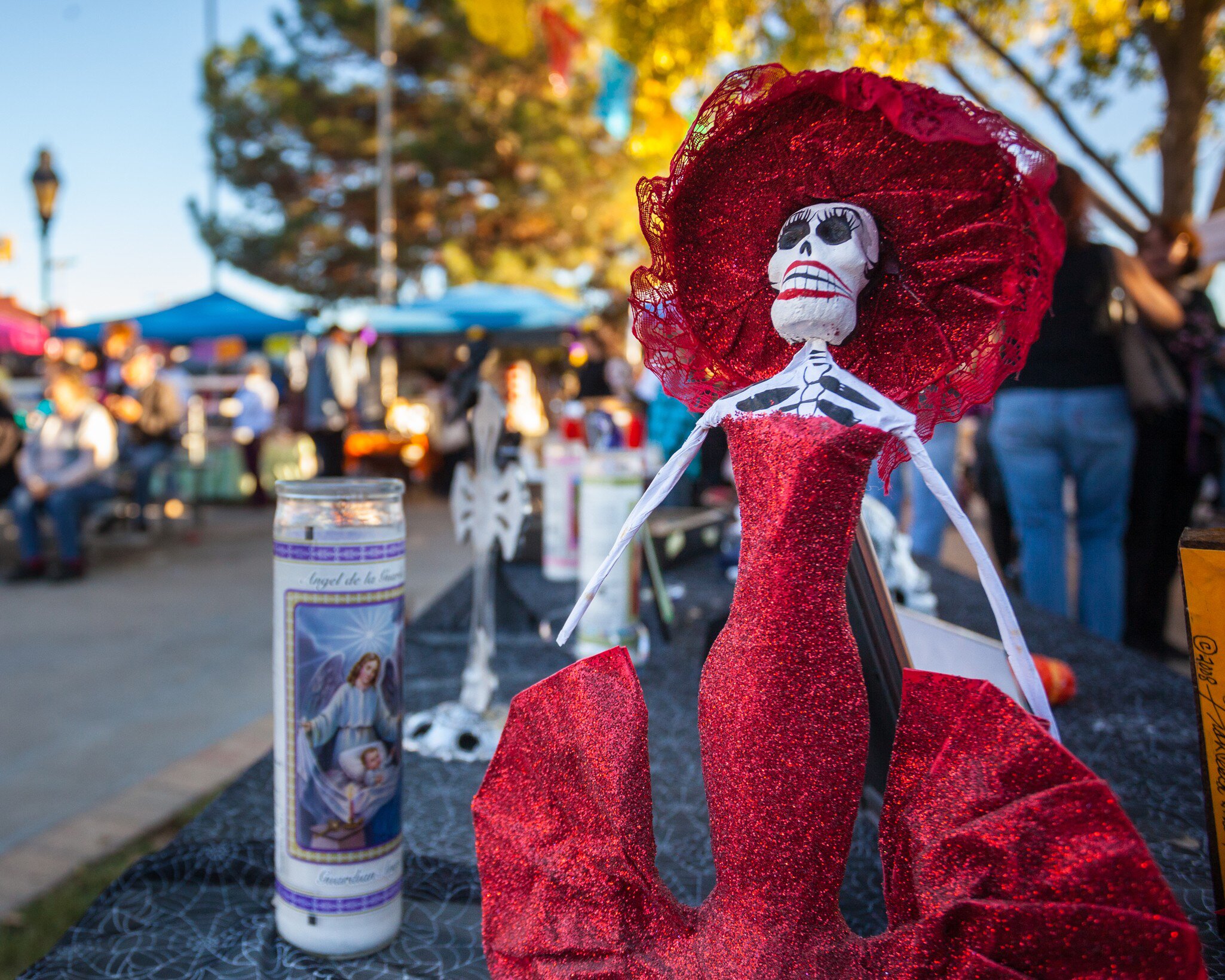 A female skeleton figure called a Catrina in a red dress at the Dia de Los Muertos / Day of the Dead altar in Mesilla, New Mexico