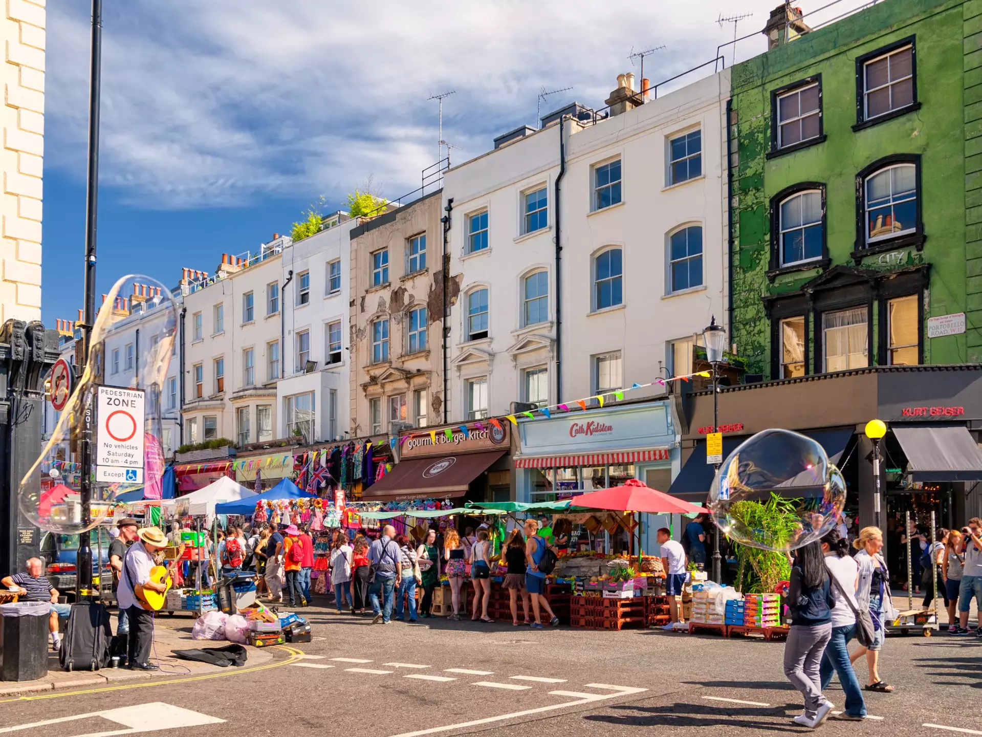 People walking in the street in Notting Hill's Portobello Road Market