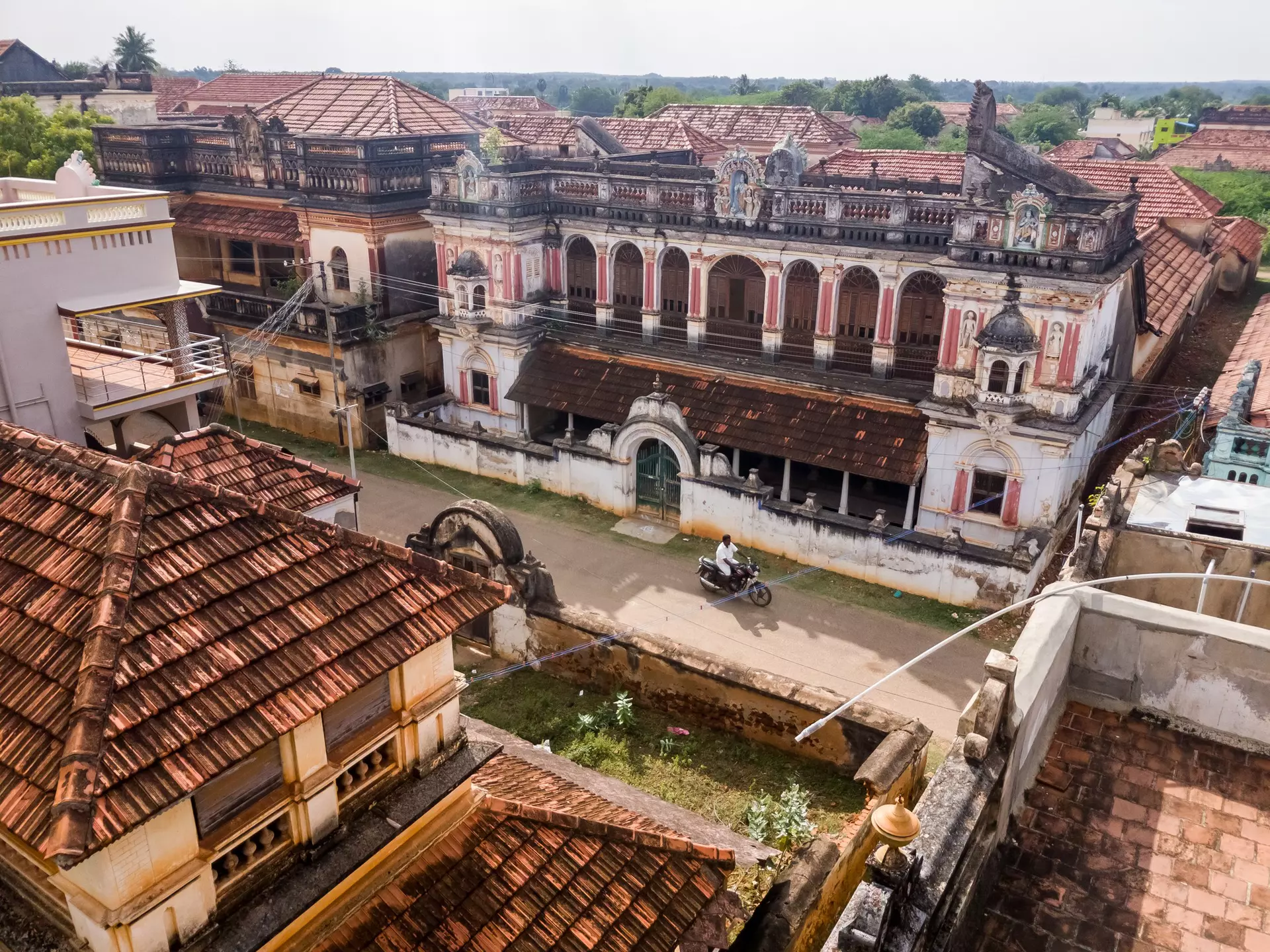 An aerial view of the roofs of historic mansions in a small village.