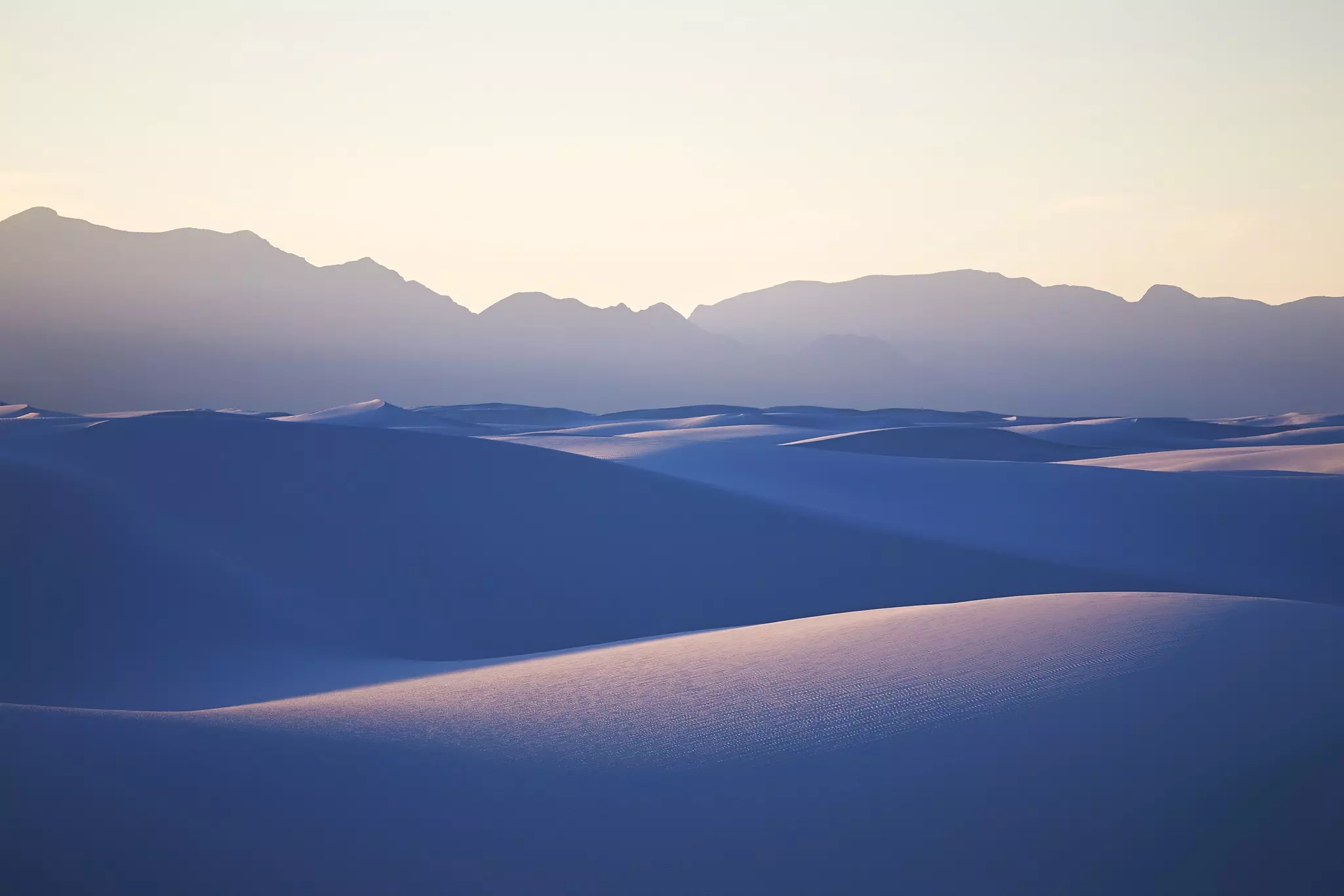 White sands rolling under a blue light