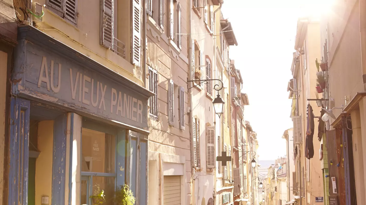 Laneway lined with shops and cafes in Le Panier district, Marseille