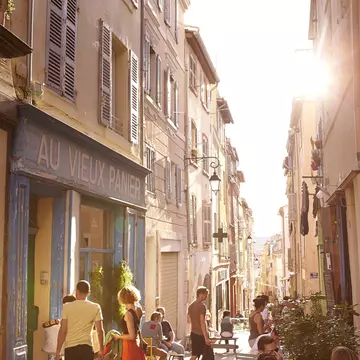 Laneway lined with shops and cafes in Le Panier district, Marseille