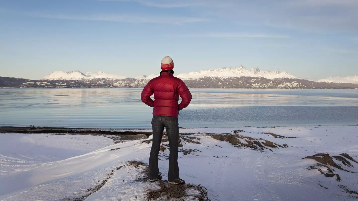 A hiker looks out at an empty landscape at Tierra del Fuego, Argentina