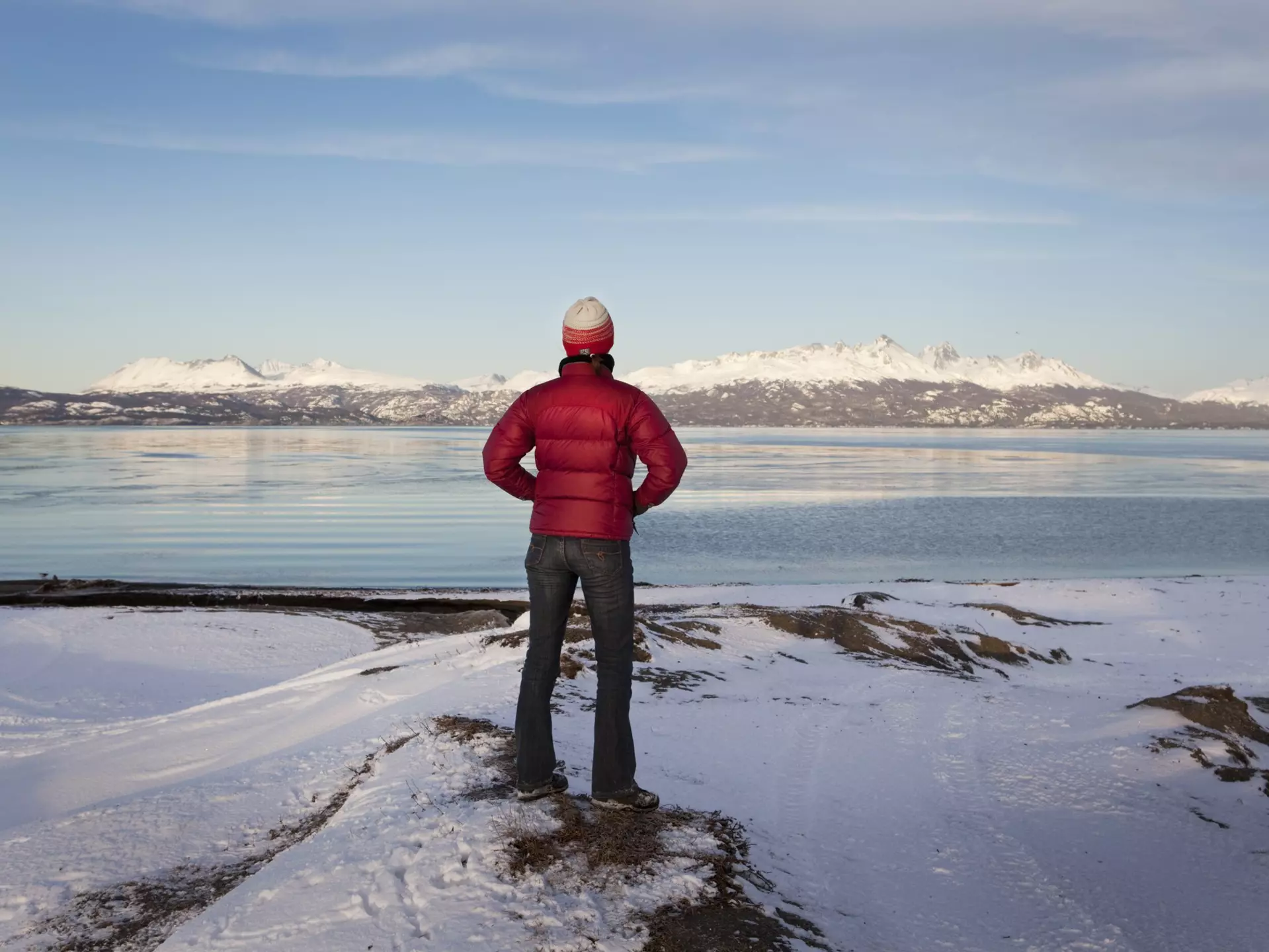 A hiker looks out at an empty landscape at Tierra del Fuego, Argentina