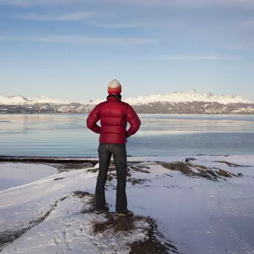 A hiker looks out at an empty landscape at Tierra del Fuego, Argentina