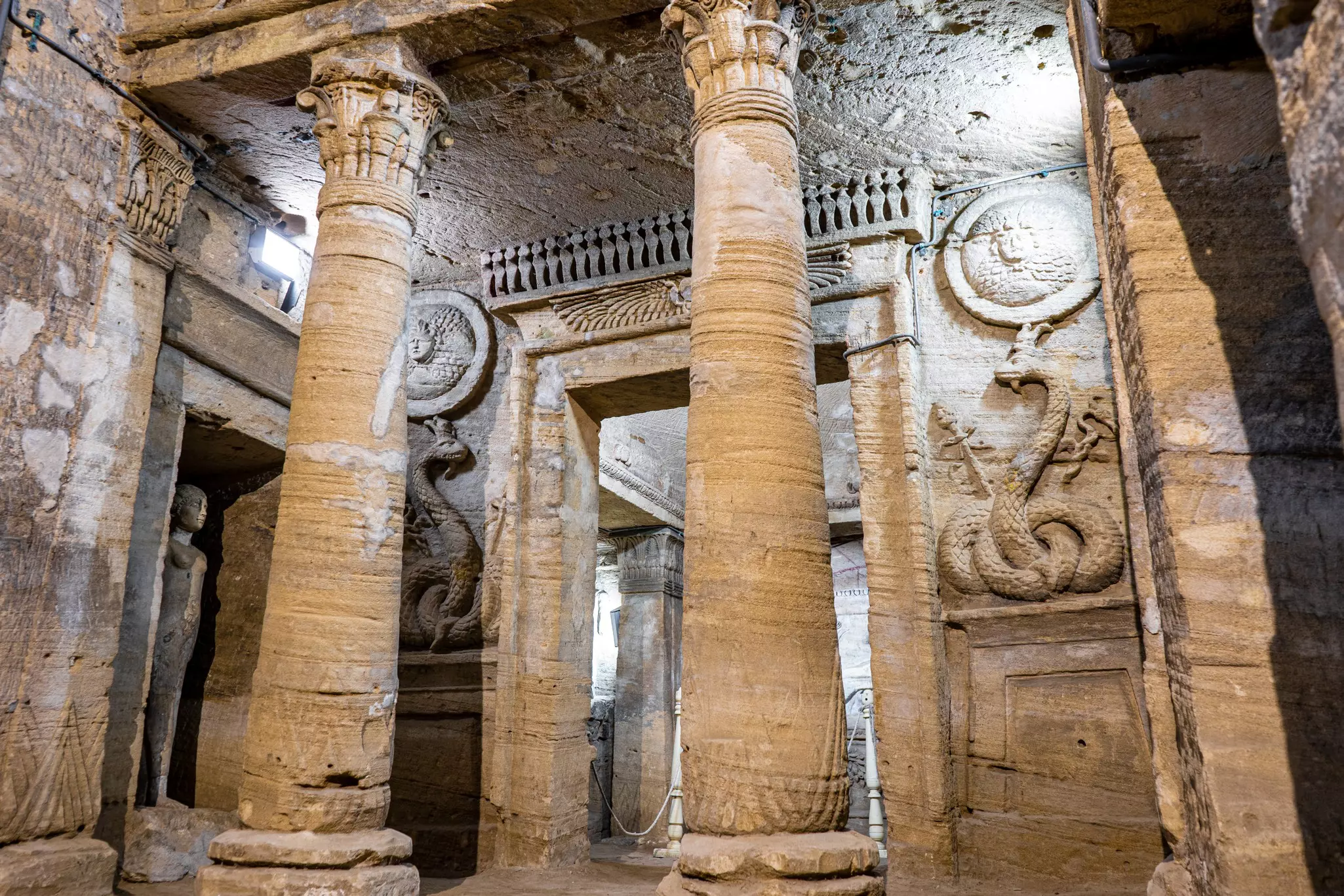 Columns in front of a carved doorway to catacombs in Egypt.