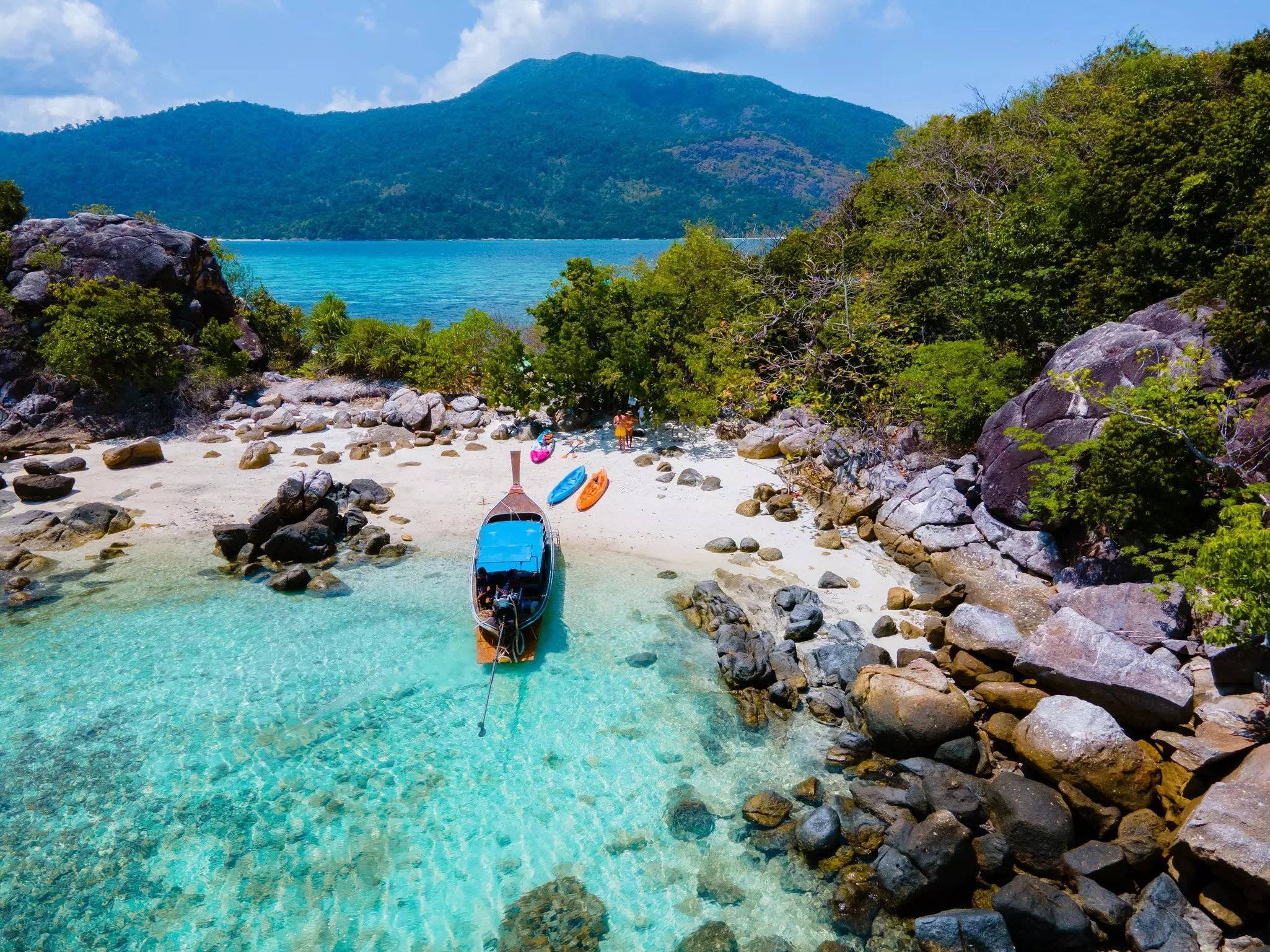 A boat docked on a sandy cove in Ko Lipe, Thailand