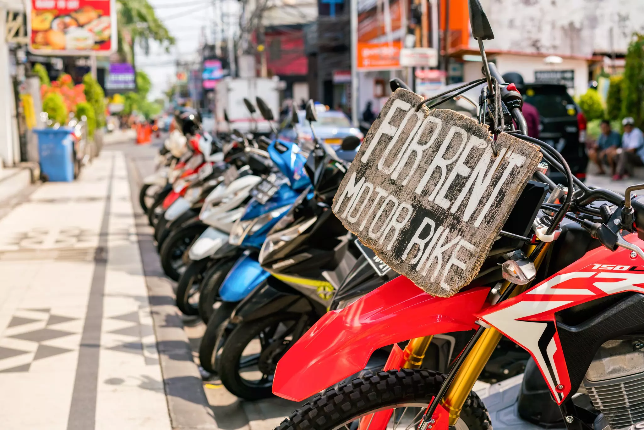 Motorcycles and scooters for rent on Legian Street in Kuta, Bali, Indonesia