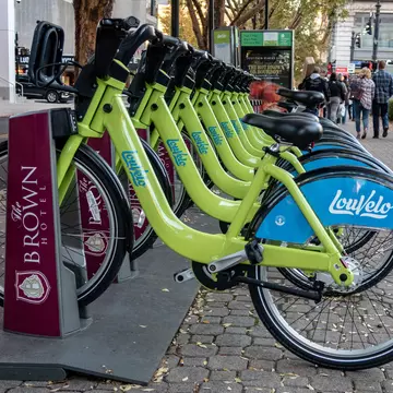 A row of green LouVelo bikes in their docks in Louisville, Kentucky