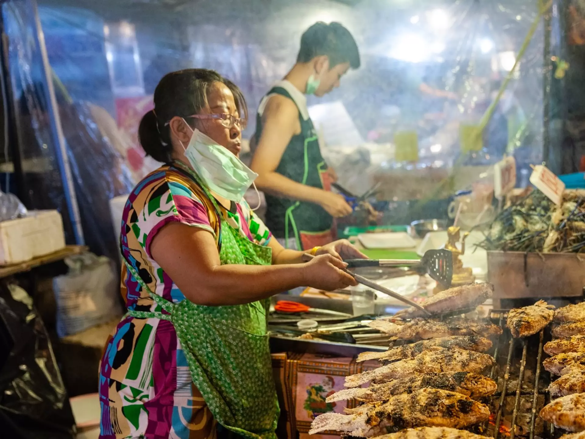 CHIANG MAI, THAILAND - AUGUST 27: Food vendor cooks fish at the Saturday Night Market (Walking Street) on August 27, 2016 in Chiang Mai, Thailand., License Type: media, Download Time: 2026-02-09T09:25:05.000Z, User: claramonitto, Editorial: true, purchase_order: 56530 - Guidebooks, job: Global Publishing-WIP, client: Thailand 20, other: Clara Monitto