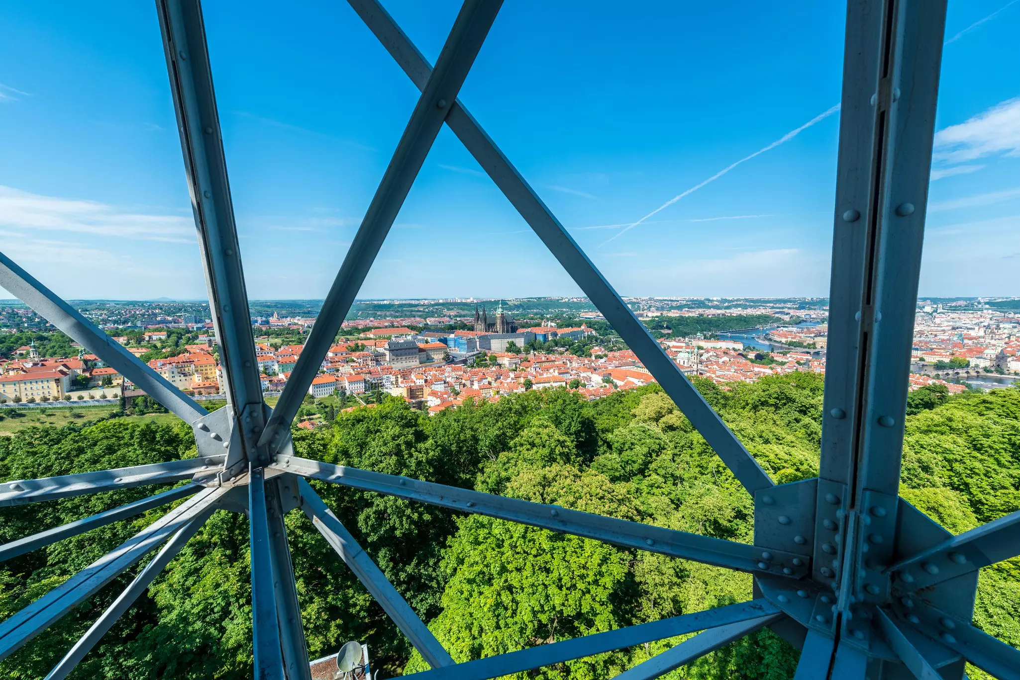 Panoramic view of a city through the steel rails of a lookout tower