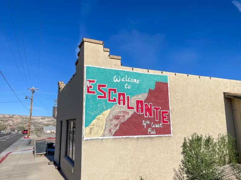 Sign 'Welcome to Escalante' on the 4th West Pub outer wall next to the main street. Escalante, a small rural town in southern Utah, gateway to national parks.