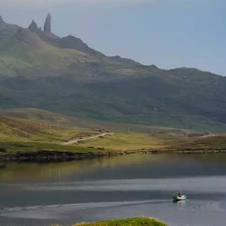 ISLE OF SKYE, SCOTLAND. AUGUST 2025
TOTAL TRIP, APPLE PAY
Views of a rowboat in Loch Leathan the Isle of Skye on the way to Old Man of Storr — you can see Old Man Storr in the background.