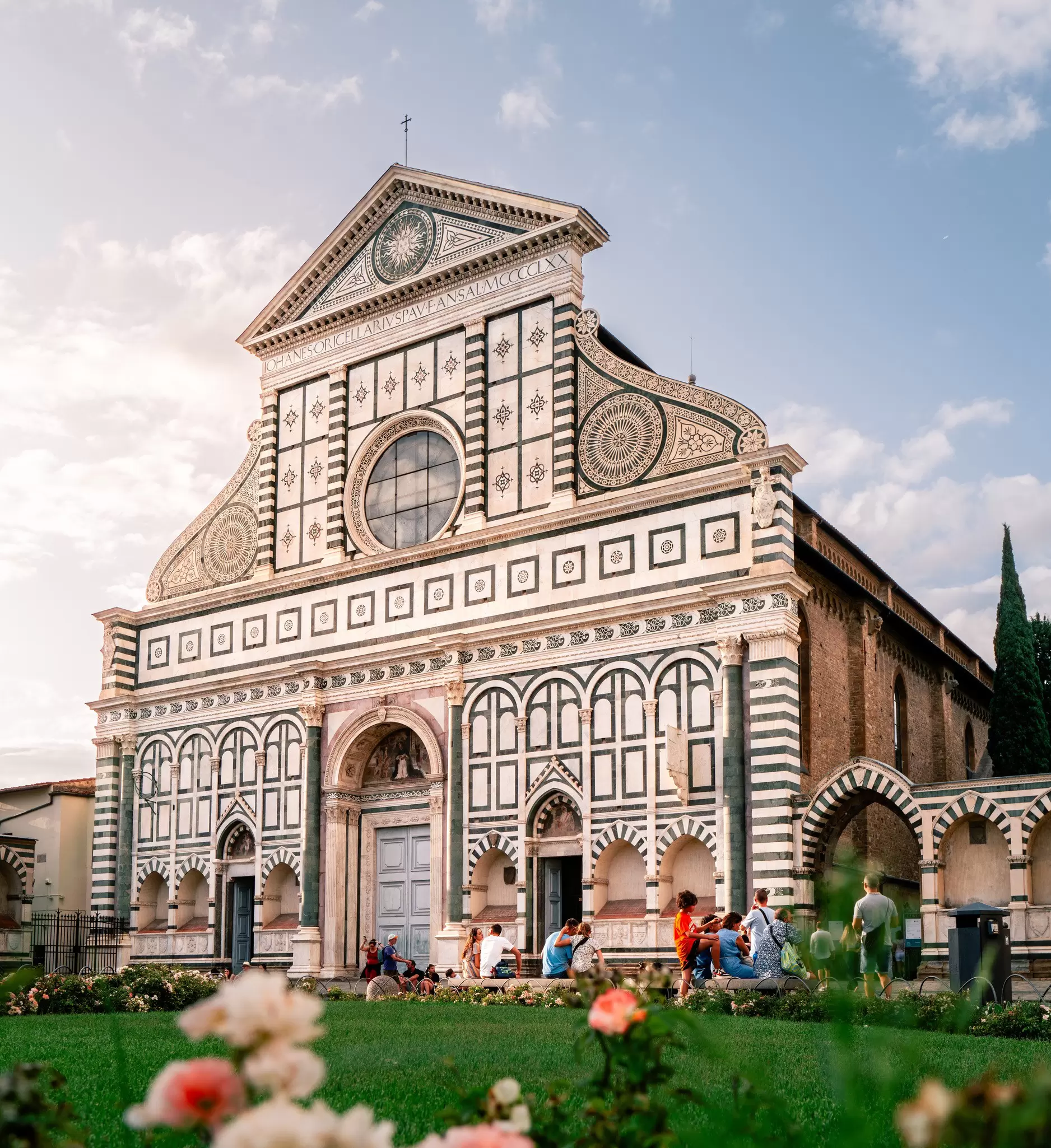 Details of the facade of the Basilica di Santa Maria Novella on a sunny summer evening in Florence, Italy.