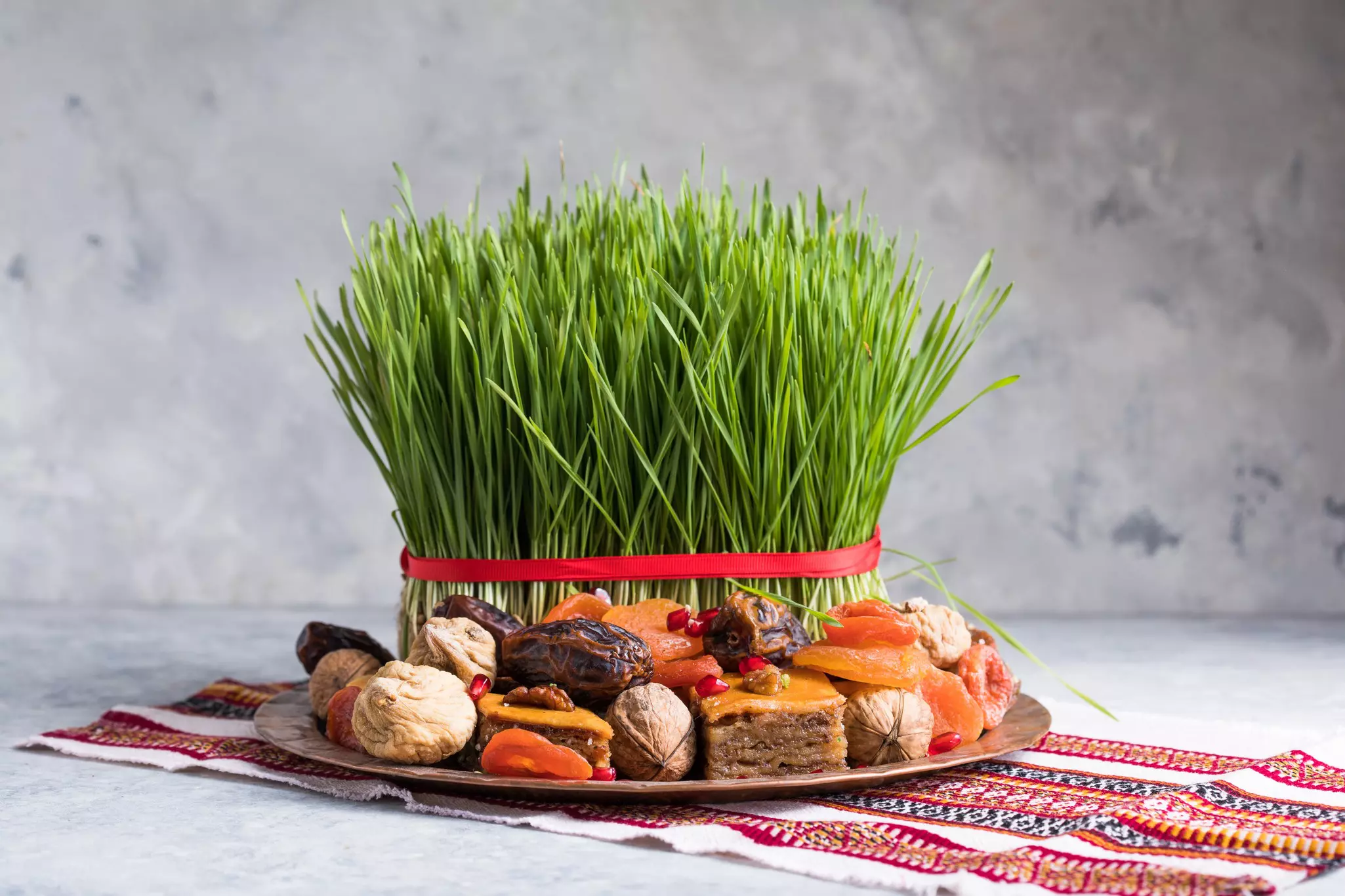 Bundles of wheatgrass, representing rebirth and renewal, are displayed during Nowruz in Iran © gorchittza2012 / Getty Images