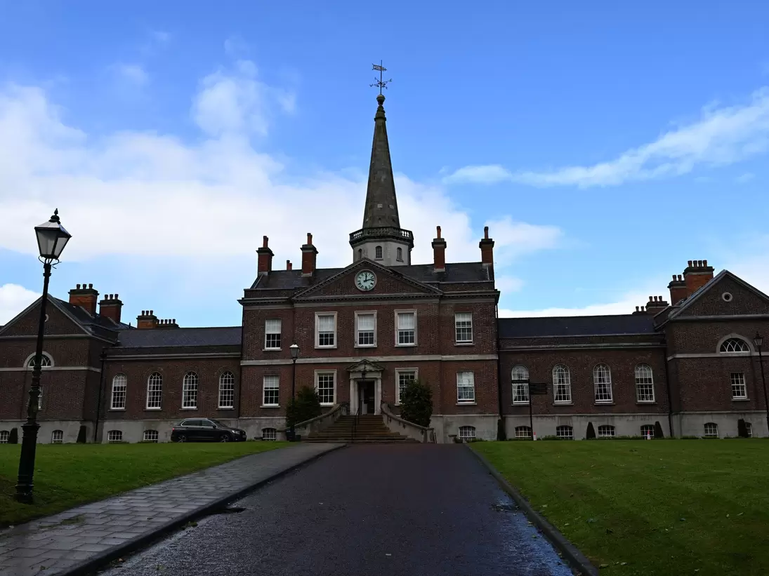 Cliften House exterior in Northern Ireland, Belfast. Clock tower with blue sky in background.