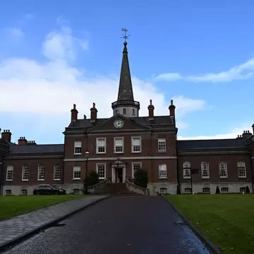 Cliften House exterior in Northern Ireland, Belfast. Clock tower with blue sky in background.