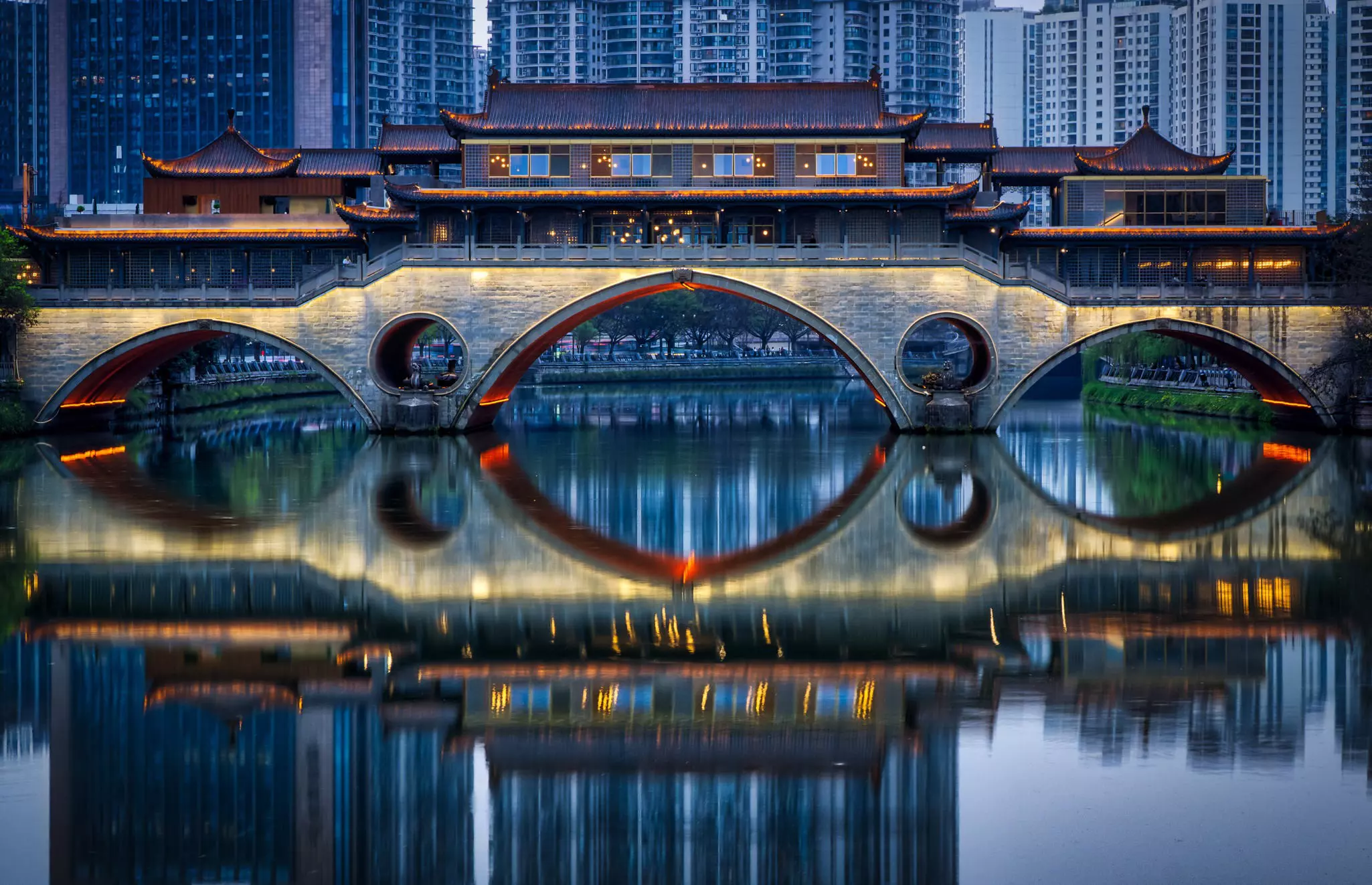 The historic Anshun Bridge reflected in the Jin River in Chengdu, Sichuan. 