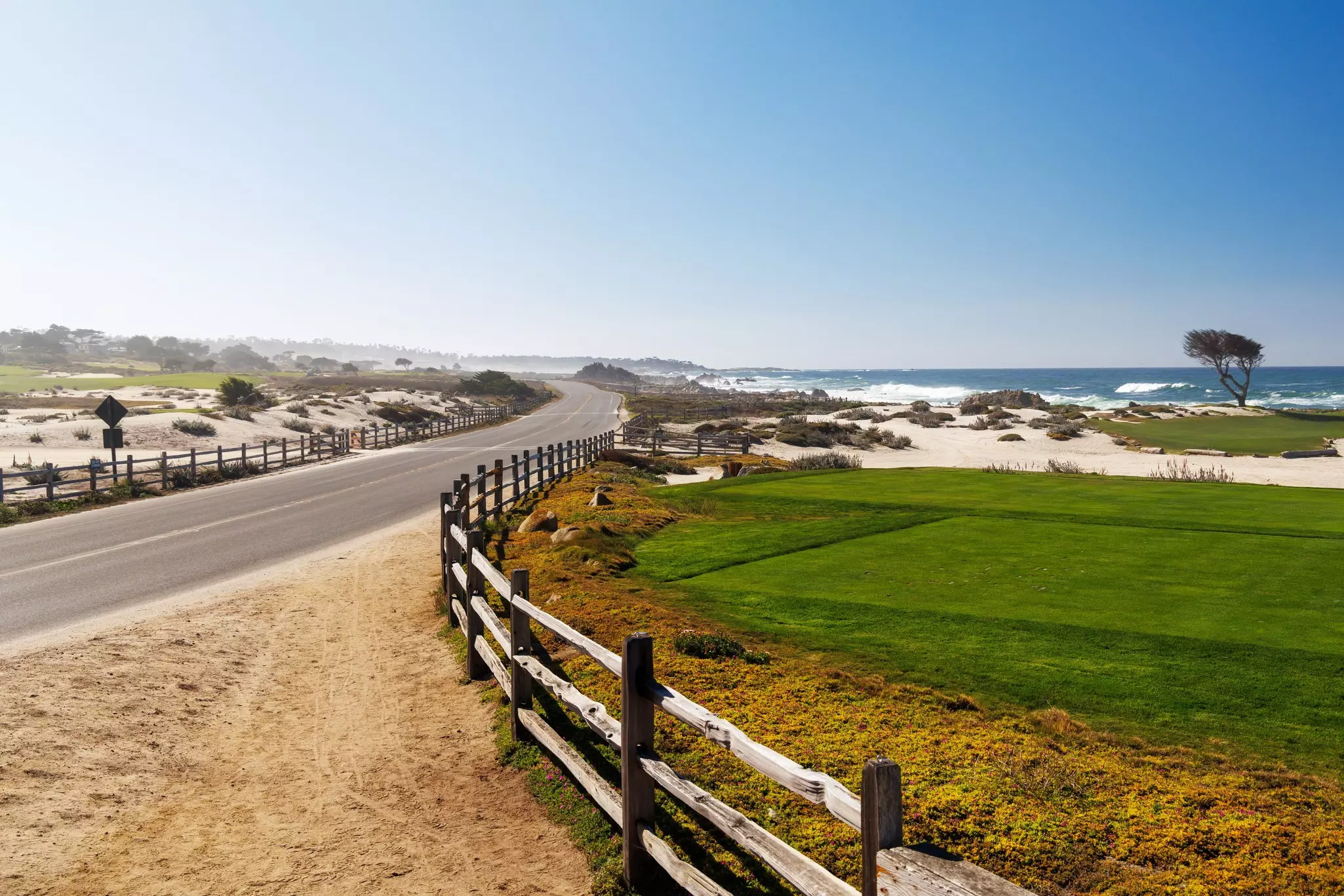 Scenic view of California 17-Mile Drive on a sunny day with ocean, road, and golf courses, License Type: media, Download Time: 2026-03-06T19:33:00.000Z, User: adouglaslott59, Editorial: false, purchase_order: 65020 - Marketing or Sales - this includes sponsored articles, job: Online editorial/sponsored article, client: Monterey County article, other: Ann Douglas Lott